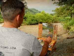 Jeremy plein air painting on the banks of the New River in Todd, NC