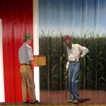 Lenoir County farmer's Market mural, Kinston NC. Detail of farmers with apples in front of the corn field by North Carolina artist, Jeremy Sams.